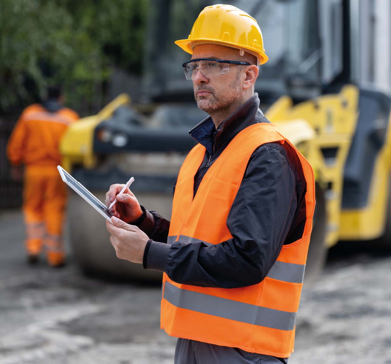 Man on worksite filling out checklist