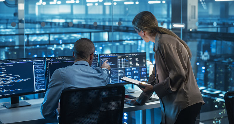 Colleagues reading from a computer screen
