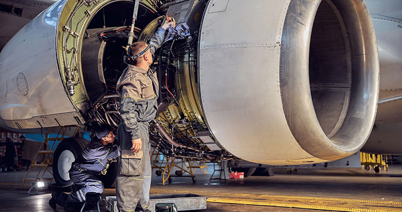 Man working on airplane engine